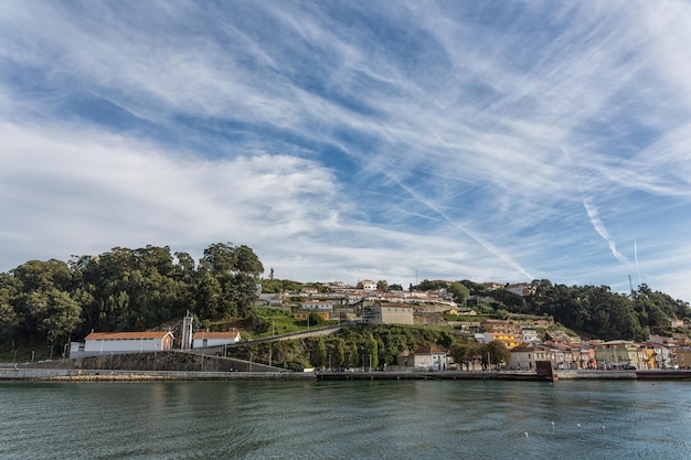 View of Porto city at the riverbank Ribeira quarter and wine boatsRabelo on River DouroPortugal a UNESCO World Heritage City