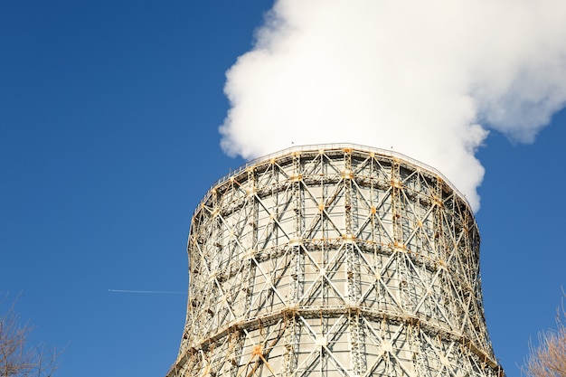 Photo view of power heat station, smoke from the chimney on a frosty winter day