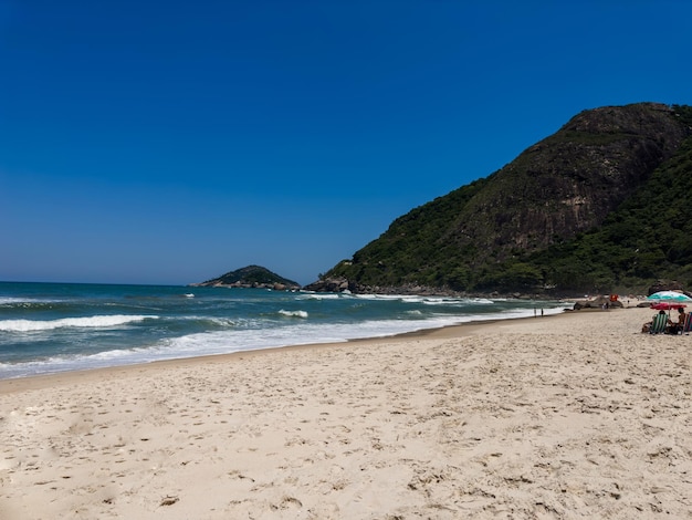 View of Prainha Beach a paradise in the west side of Rio de Janeiro Brazil Big hills around Sunny day