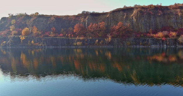 A view of a quarry pond created by mining stone with clear turquoise water that stretches for miles in the distance