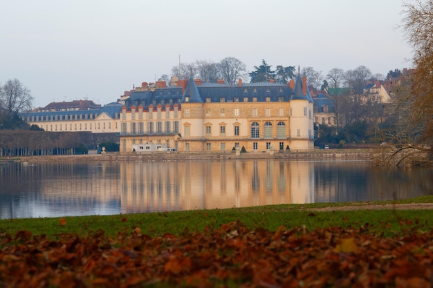 View of Rambouillet castle XIV century in picturesque Public Park in town of Rambouillet 50 km southwest of Paris France