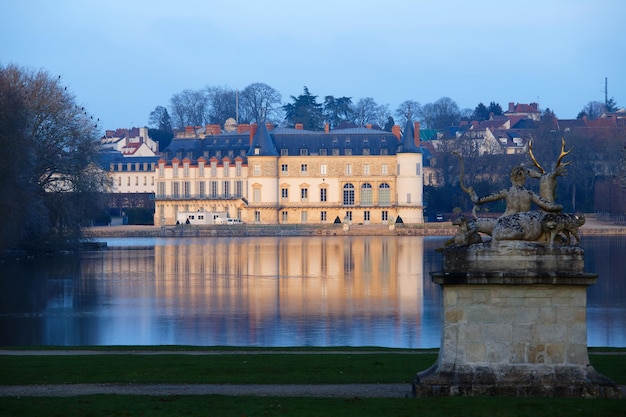 View of Rambouillet castle XIV century in picturesque Public Park in town of Rambouillet 50 km southwest of Paris France