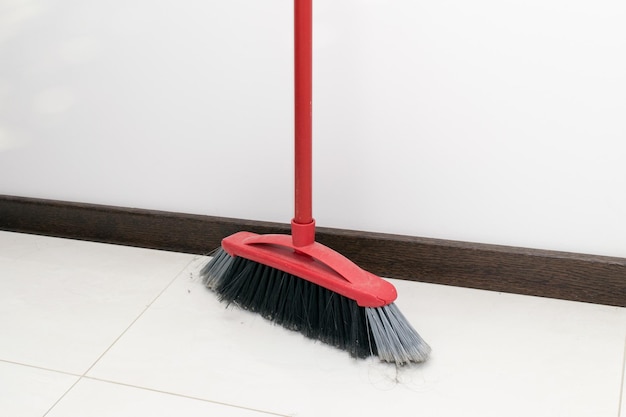 View of the red sweeping brush in the kitchen