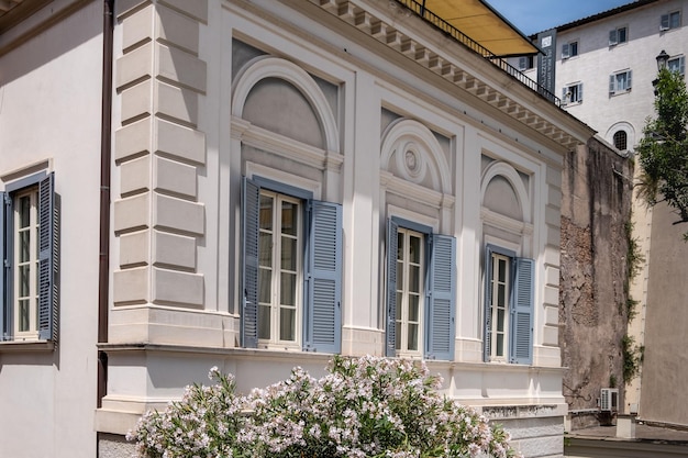 View to renovated fabulous light terracotta stone building with rooftop plants thuja