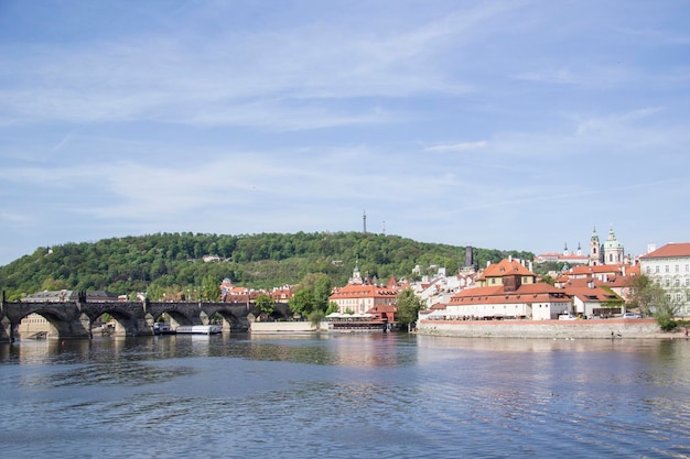 A view of the river vltava with a bridge in the background