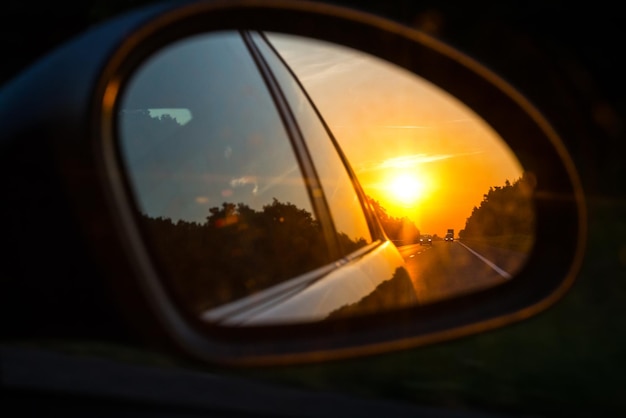 View of the road in the side mirror of a car