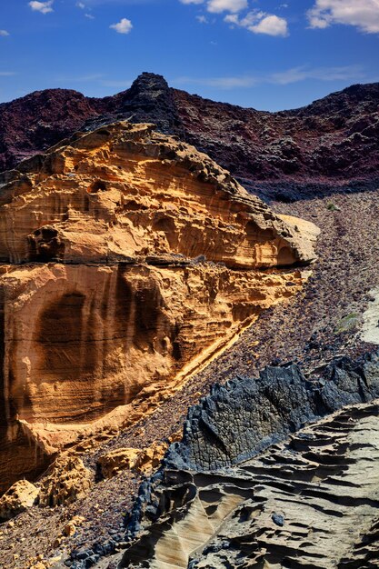 View of the rocky wall of the volcano Monte Nero in Linosa Sicily