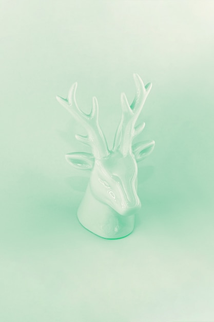 View of the sculpture of a Christmas deer in neo mint color. Winter vacation concept, minimalism, abstraction, color of the year.