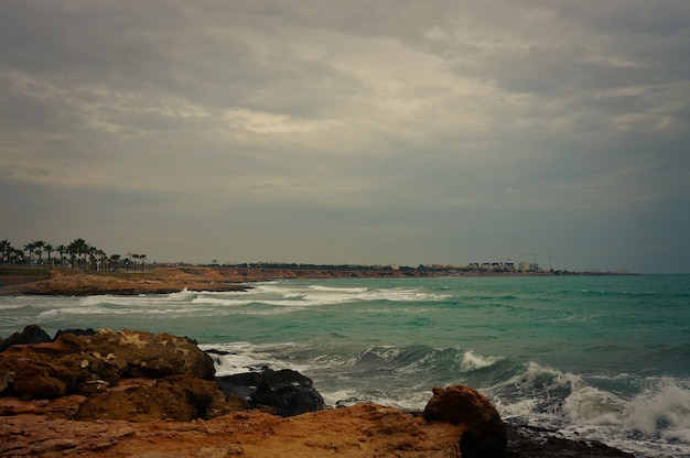 View to the sea from Flamenca beach on windy weather. 