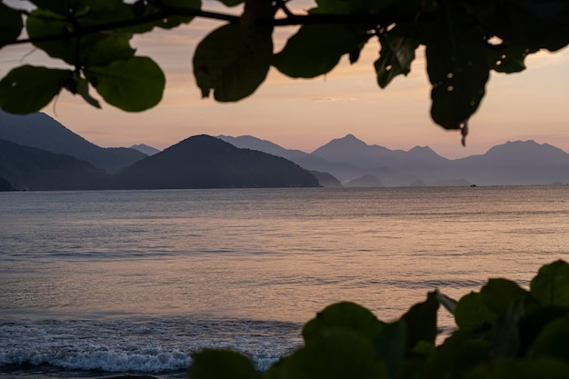 View of the sea and mountains in the distance at dawn