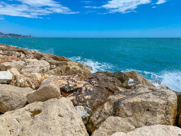 View of the sea reaching the cliffs in Malaga Mediterranean Sea in the summer