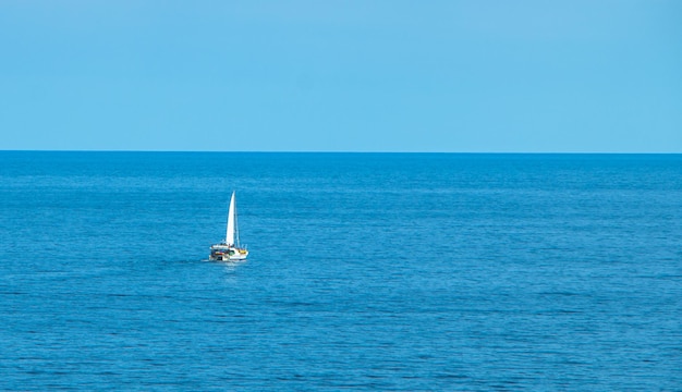 view of the sea and sailboat in the city of Lloret de Mar Catalonia