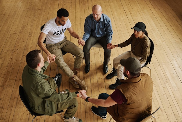 Above view of several attendants of support group and their counselor