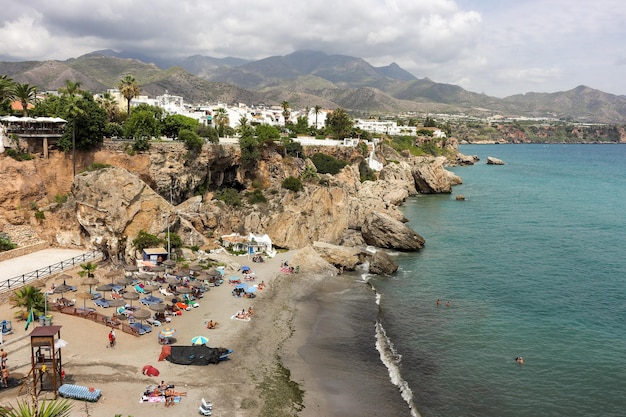 View of the Sierra de Almijara with the beaches of nerja in the foreground in daytime with storm clo