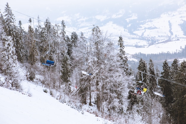 View of ski resort lift mountains in fog landscape winter vacation