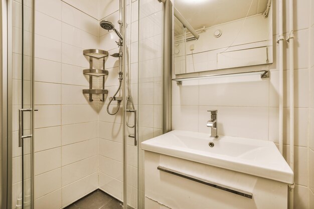 View of a small bathroom in a cozy house with a shower sink and mirror