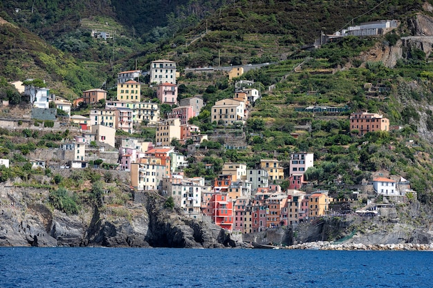 View on small city Riomaggiore from ship. Liguria, Cinque Terre. Italy