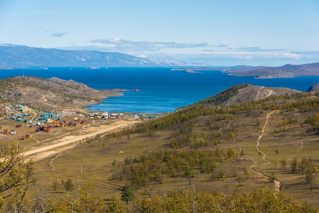 View of small sea strait on lake baikal on autumn day joy bay with houses