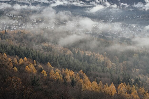 View of a small town among the mountains surrounded by mist landscape