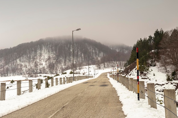 View of the snowcapped foggy roads in the mountains Epirus region Greece