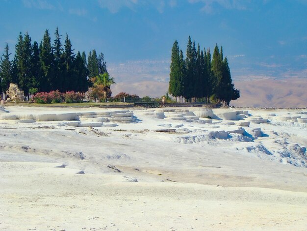 View of the snowwhite travertines of Pamukkale Mountains on the background Turkey