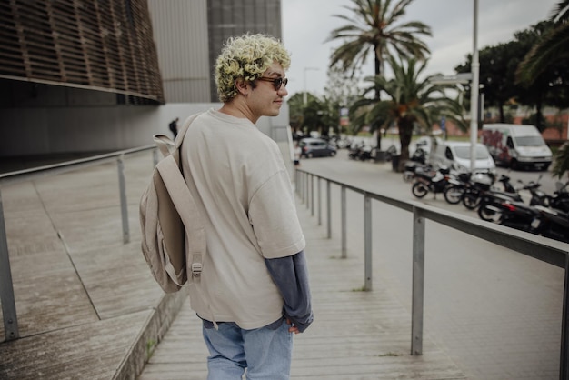 View of stylish man with backpack in the city