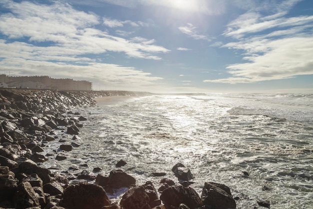 View of the sunrise, and the glow of the sun's rays reflecting off the Furadouro beach in Portugal.