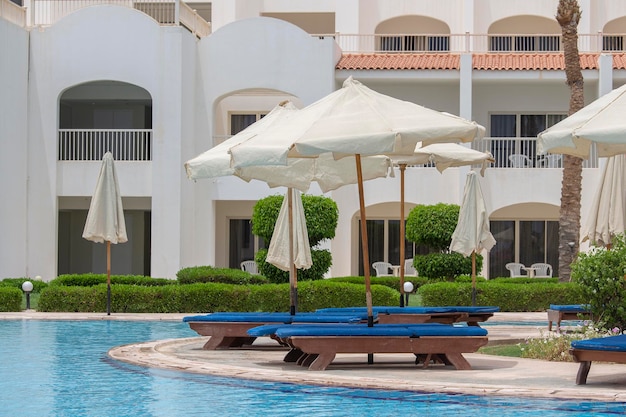 The view the swimming pool sun umbrellas and deck chairs in Sharm el Sheikh Egypt