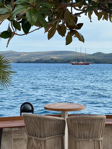 View of the threemasted sailboat from the terrace of the restaurant on the pier