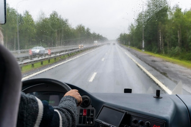 View through the windshield of a tourist bus moving along the highway