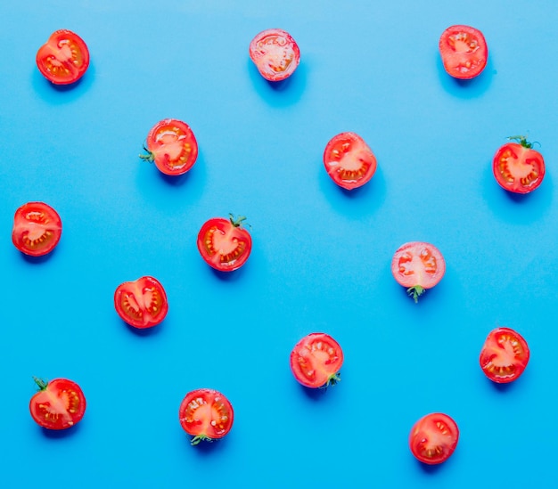 Above view at tomatoes on blue background