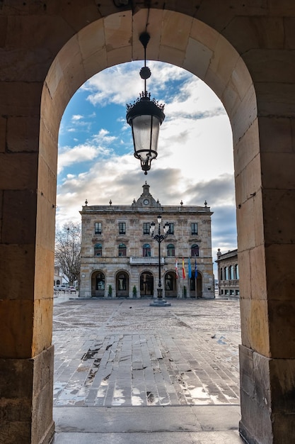 View of the town hall of the city of Gijon from one of the arches that surround the Plaza Mayor Asturias