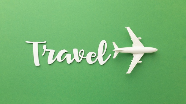 Above view travel items on green background