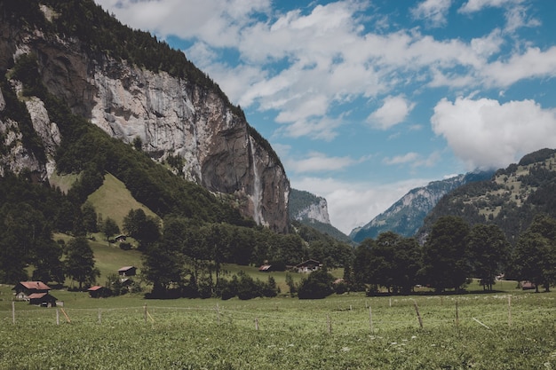 View valley of waterfalls in national park of city Lauterbrunnen, Switzerland, Europe. Summer landscape, sunshine weather, dramatic blue sky and sunny day