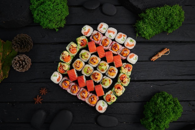 Above view of various sushi and rolls placed on stone board japanese food fest top view flat lay