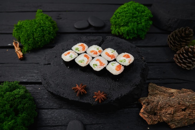 Above view of various sushi and rolls placed on stone board japanese food fest top view flat lay