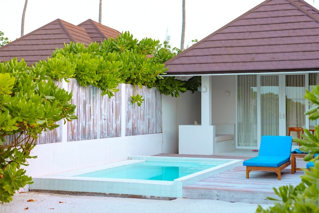 view on villa with pool at sunrise in the Maldives, the concept of luxury travel