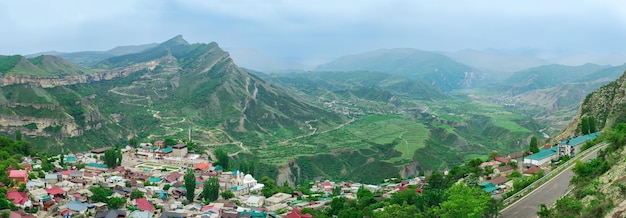 View of the village of Gunib on a mountainside and a foggy mountain valley behind it North Caucasus landscape