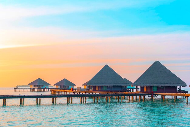 View of the water villas at sunrise in the Maldives the concept of luxury travel