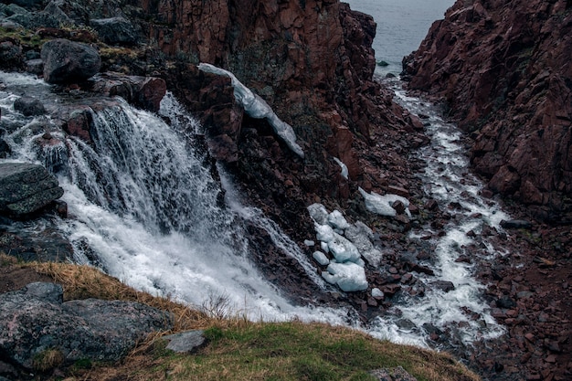 View of the waterfall flowing into the Barents Sea