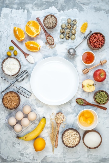 Above view of white plate and ingredients for the healthy foods selection on ice background