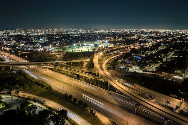 Above view of wide highway crossroads in Miami Florida at night with fast driving cars USA transportation infrastructure concept