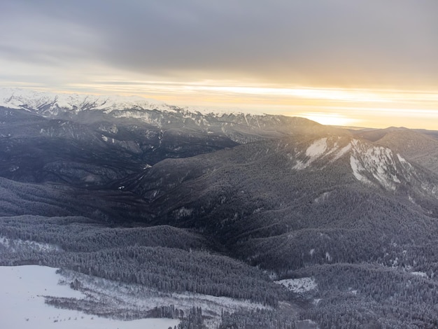 View of the winter sunset and snowcovered mountains in Sochi