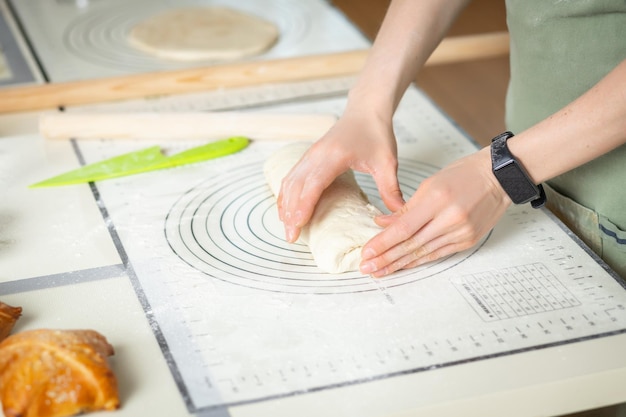 View of woman hands with electronic fitness bracelet cooking homemade cakes