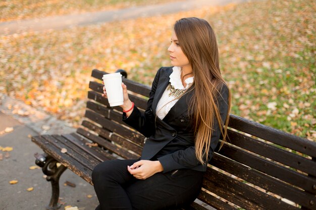 View of the woman holding a mug with coffee