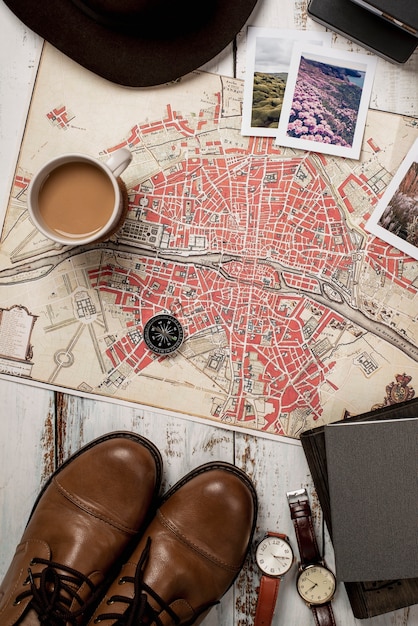 View of world travel map with shoes and coffee