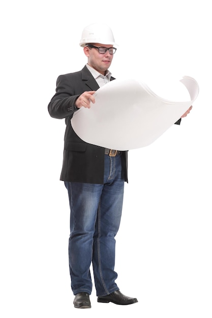 A view of a young construction worker wearing helmet and holding blueprints