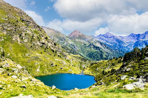 Views of the Tristaina lake in Ordino Andorra under the mountains on a cloudy day