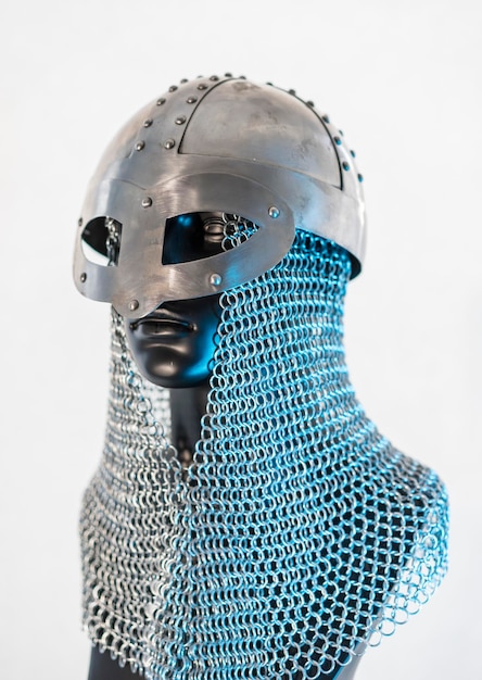 Viking helmet with chain mail in a black mannequin on white background clothes for the viking war