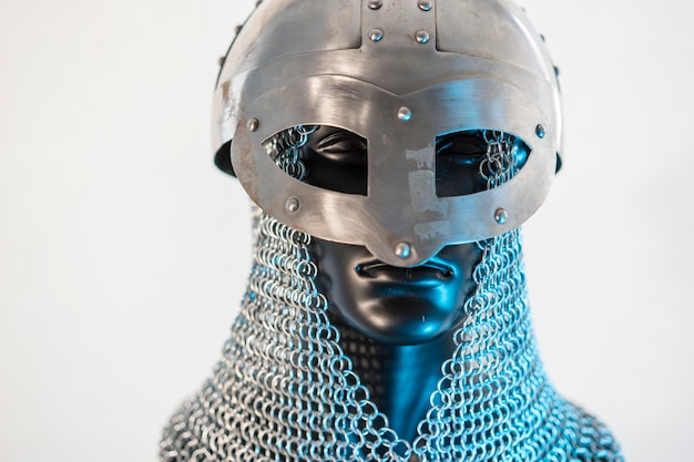 Viking helmet with chain mail in a black mannequin on white background clothes for the viking war